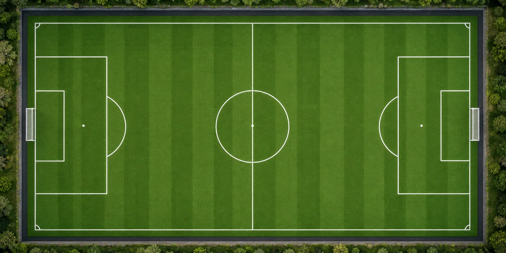 Aerial view of a complete football field with clearly marked centre circle, penalty areas, goal areas and corner arcs