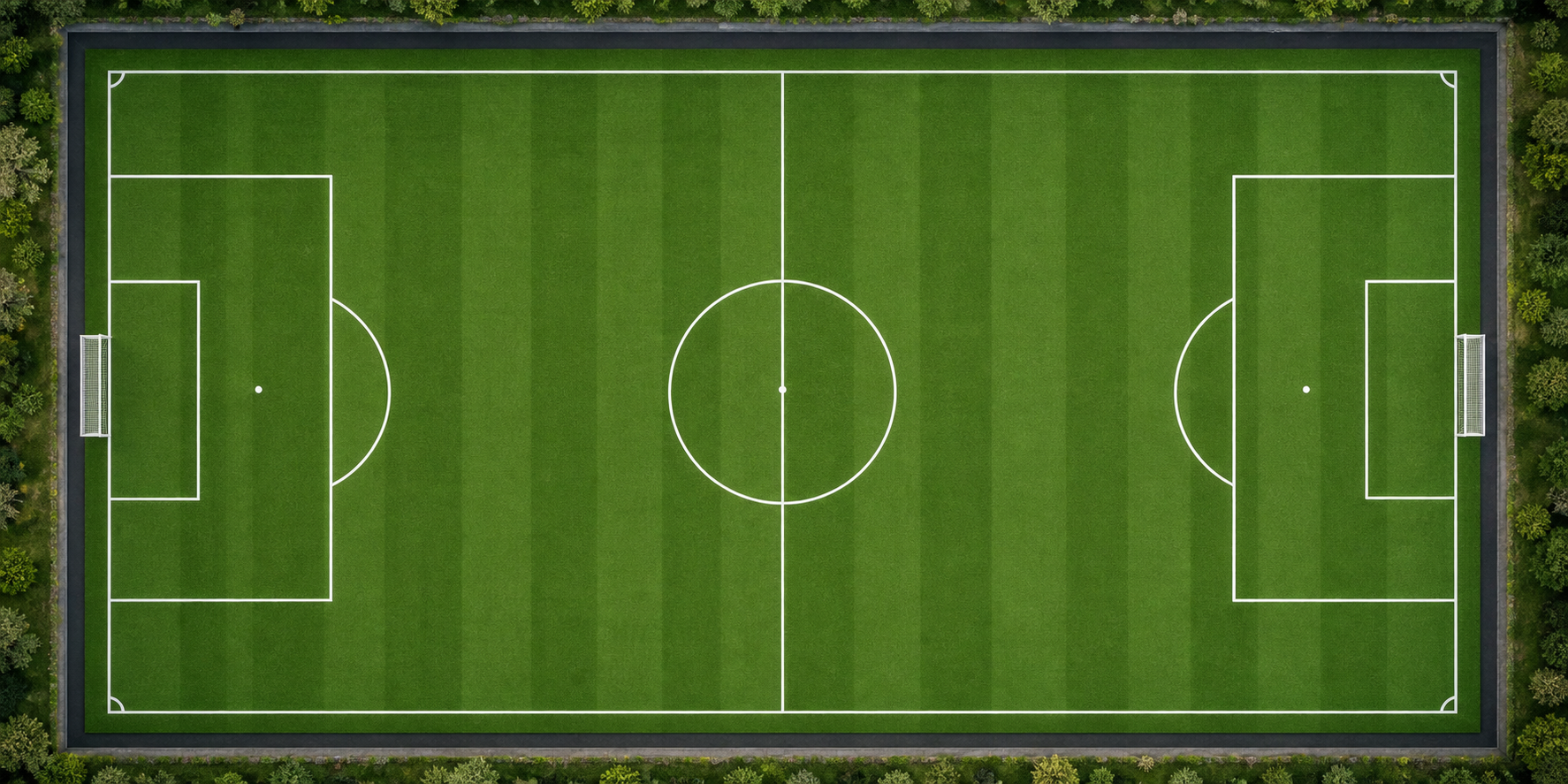 Aerial view of a complete football field with clearly marked centre circle, penalty areas, goal areas and corner arcs