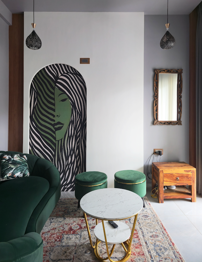 Executed portrait view of green lounge seating, art feature wall and pendant lights