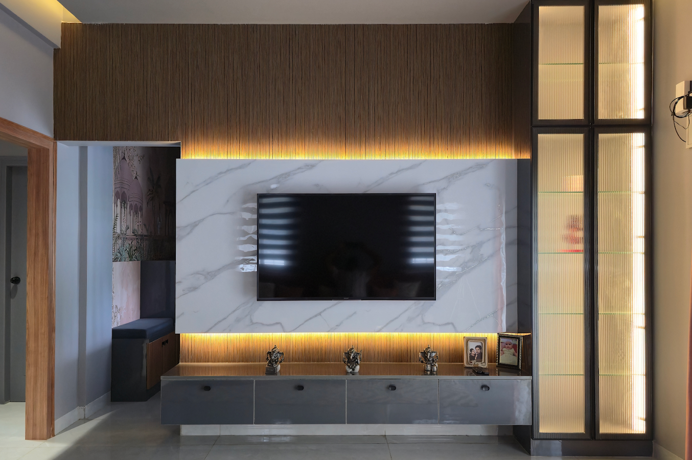 Executed media wall with marble finish, fluted panels and integrated lighting