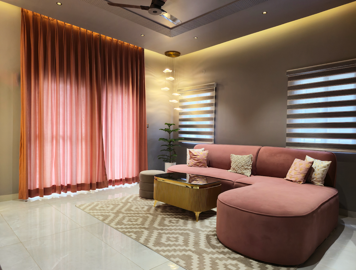 Executed living room interior with curved rose seating and full-height curtains